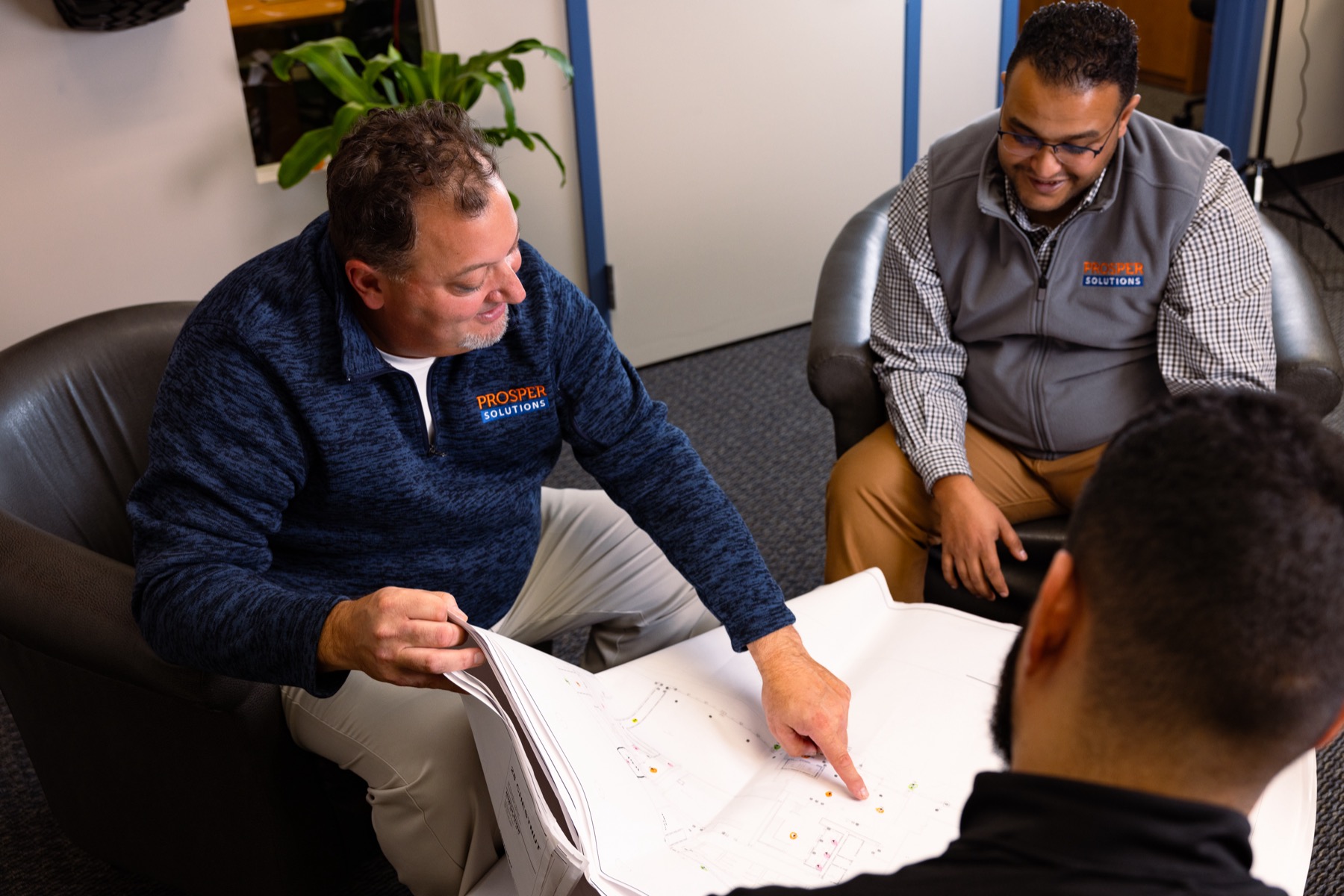 The Prosper team reviewing plans with a client